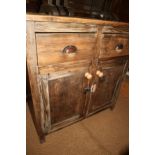 A grey painted pine cupboard, fitted two drawers over cupboards, on block base, 36" wide