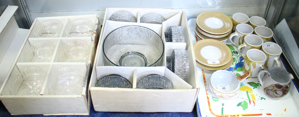 A set of seven Aldermaston pottery coffee cans and saucers with cream jug and sugar dish, a