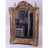 A gilt framed arch top wall mirror, in deep gilt swept frame, plate 15" x 9"