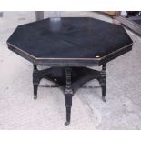 An Arts & Crafts ebonised octagonal centre table, on turned supports united by shaped undertier,