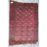 A Bokhara rug of traditional design with twenty-four guls, 58" x 42" approx
