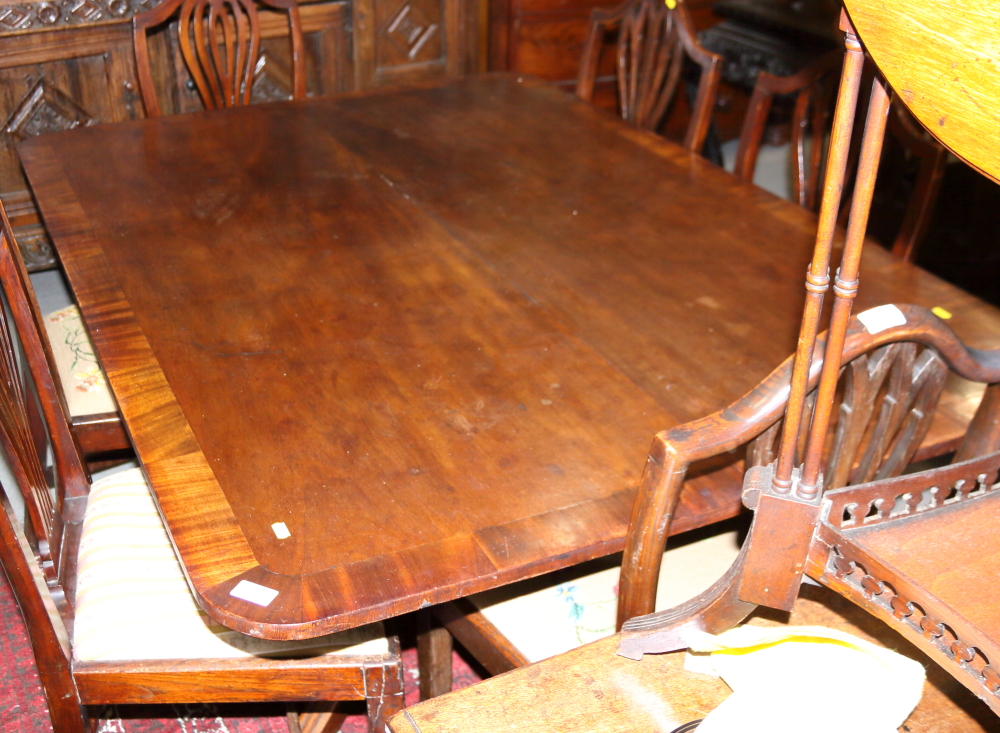A Regency banded mahogany rectangular topped breakfast table, on turned column and quadruple splay