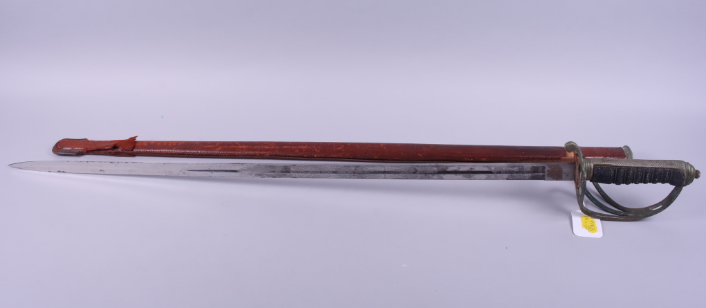 A Royal Artillery sword, in leather sheath, said to be owned by Colonel Buckthort Hooten-Oliver OBE,