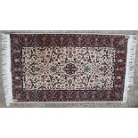 A Persian rug with all-over tendril design, on a cream ground, 63" x 37" approx