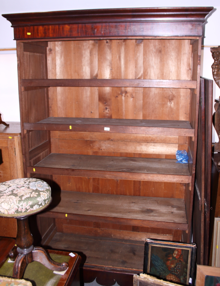 A Victorian mahogany wardrobe, the interior fitted trays enclosed two Gothic panel doors, on