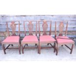 Four splat back dining chairs with drop-in seats, upholstered in a red fabric, on square chamfered