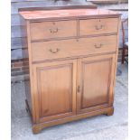 An early 20th century mahogany linen cupboard, fitted two short and one long drawer over cupboard