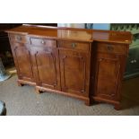 A Brights of Nettlebed figured mahogany breakfront sideboard, fitted four drawers over cupboards, on