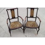 A pair of Edwardian polished as walnut elbow chairs with padded seat and backs, on turned and