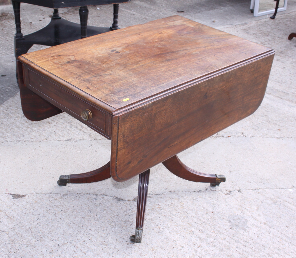 An early 19th century mahogany Pembroke table, fitted one drawer, on turned column and quadruple