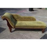 A late 19th century walnut showframe chaise longue, upholstered in a green corded fabric, on