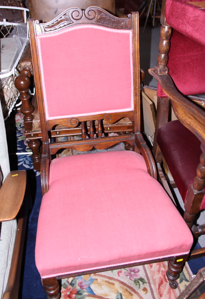 An early to mid 20th century mahogany framed nursing chair, upholstered in a red fabric