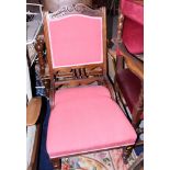An early to mid 20th century mahogany framed nursing chair, upholstered in a red fabric