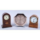 An Edwardian mahogany and inlaid mantel clock, an oak cased mantel clock and a modern Temco electric