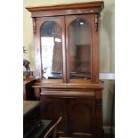 A 19th century walnut bookcase, the upper section enclosed two arched panel doors over one drawer