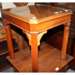 A set of three figured walnut lamp tables on chamfered supports, 18” square