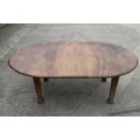 A 1920s Chinese rosewood oval extending dining table with extra leaf and two under frames, on square