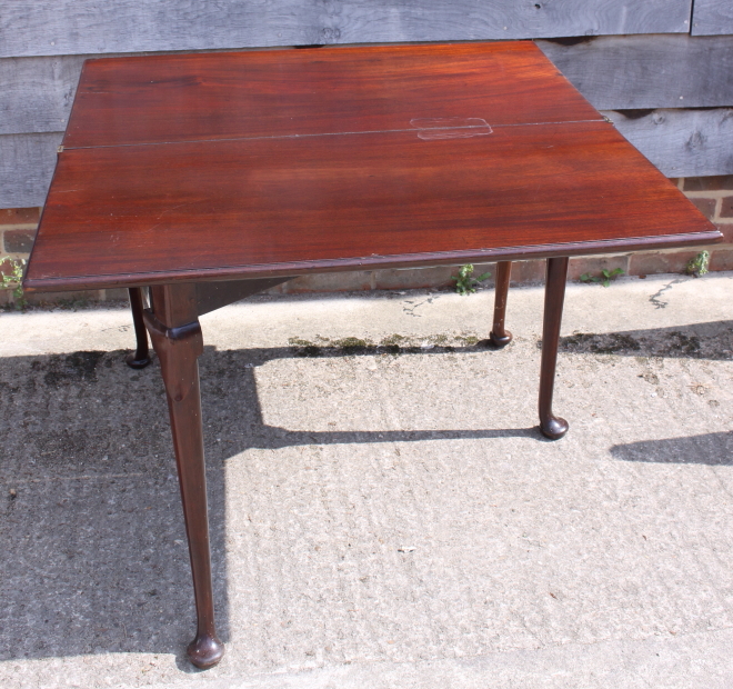 A 19th century mahogany fold-over top tea table, on pole turned supports and pad feet, 35" wide - Image 2 of 2