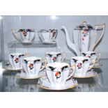 A Shelley Art Deco Queen Anne shape "Damson" pattern coffee set for six with orange accents (hand