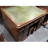 A partners Victorian mahogany double pedestal desk with tooled green leather lined top, fitted seven