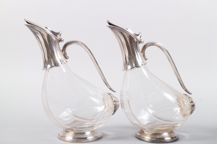 A pair of melon-shape claret jugs with silver plated mounts, 9 1/2" high