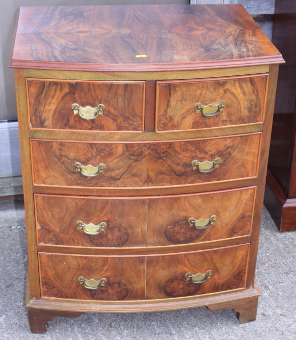 A figured walnut bowfront chest of two short and three long graduated drawers, on bracket feet,