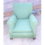 An armchair, upholstered in a green fabric, on castored bun feet