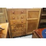 A Heal's style light oak chest/wardrobe, fitted two fall front drawers, four long drawers and