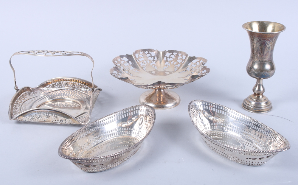 A pair of pierced silver boat-shaped baskets, a pierced silver pedestal dish, a pierced silver swing