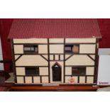 A doll's house with fitted interior and furniture, 32" wide