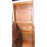 A mid 20th century teak bookcase, on stile supports, 29 1/2" wide x 72" high, and an oak low