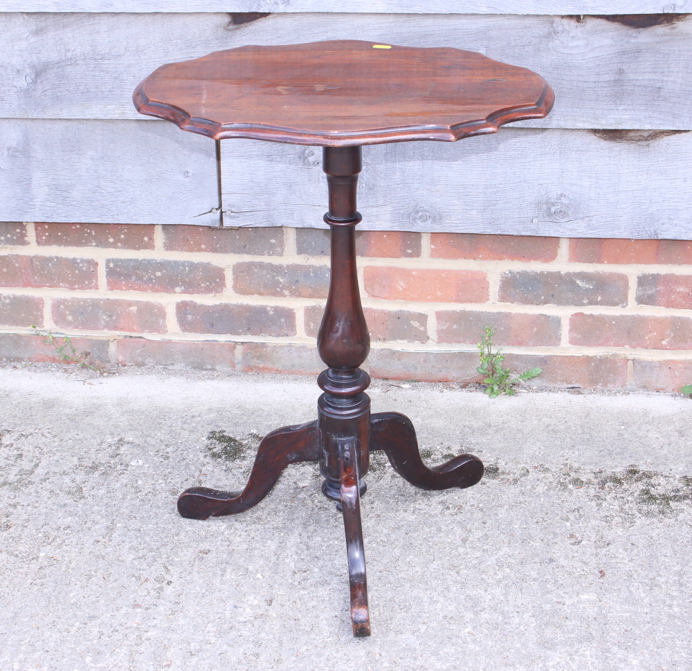 A late 19th century mahogany shape top occasional table, on turned column and tripod splay supports,