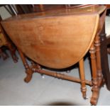 A walnut Sutherland tea table, on twin turned end supports and splay feet, 34" wide