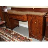A Victorian mahogany sideboard with central frieze drawer flanked two panel doors enclosed drawers