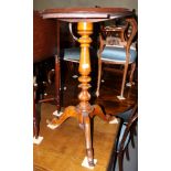 An oak torchere stand with turned column, on tripod splayed supports, 19" dia x 30" high