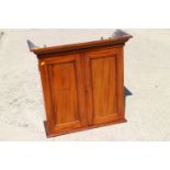 A 19th century walnut wall cupboard enclosed two panelled doors, 28" wide x 27 3/4" high