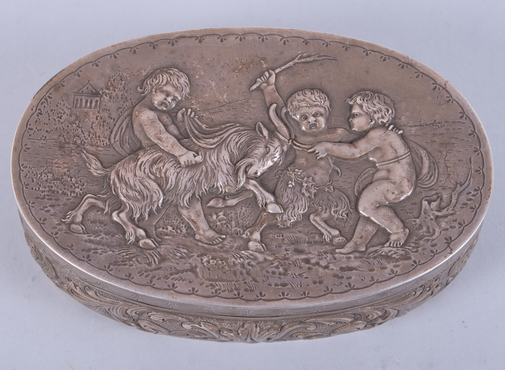 A Continental silver box with hinged lid, decorated in cherubs and a ram, 8.7oz troy approx, and a