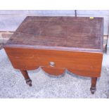 An early 19th century mahogany bidet stool with cream ware liner, on turned and tapering supports,