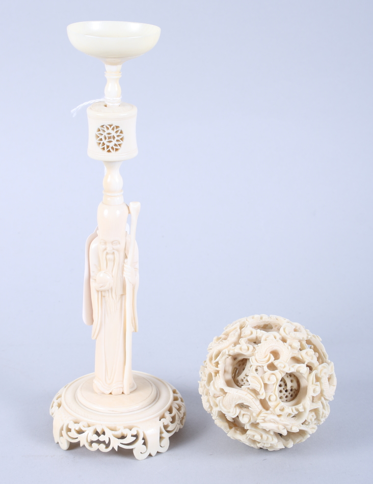 A Chinese carved ivory nesting ball with dragon design, on ivory stand formed as Lao Tzu, ball 2 1/