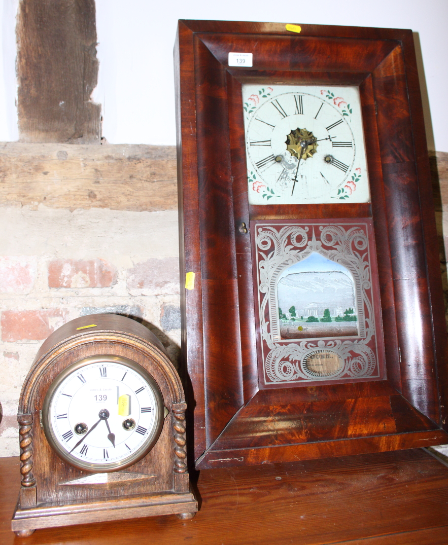 A 19th century American mahogany cased wall clock, 26" high, and an oak cased mantel clock with