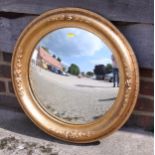 A gilt framed convex wall mirror, 21" dia