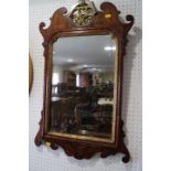 A figured walnut framed wall mirror of early Georgian design with pierced gilt crest, plate 19" x 12