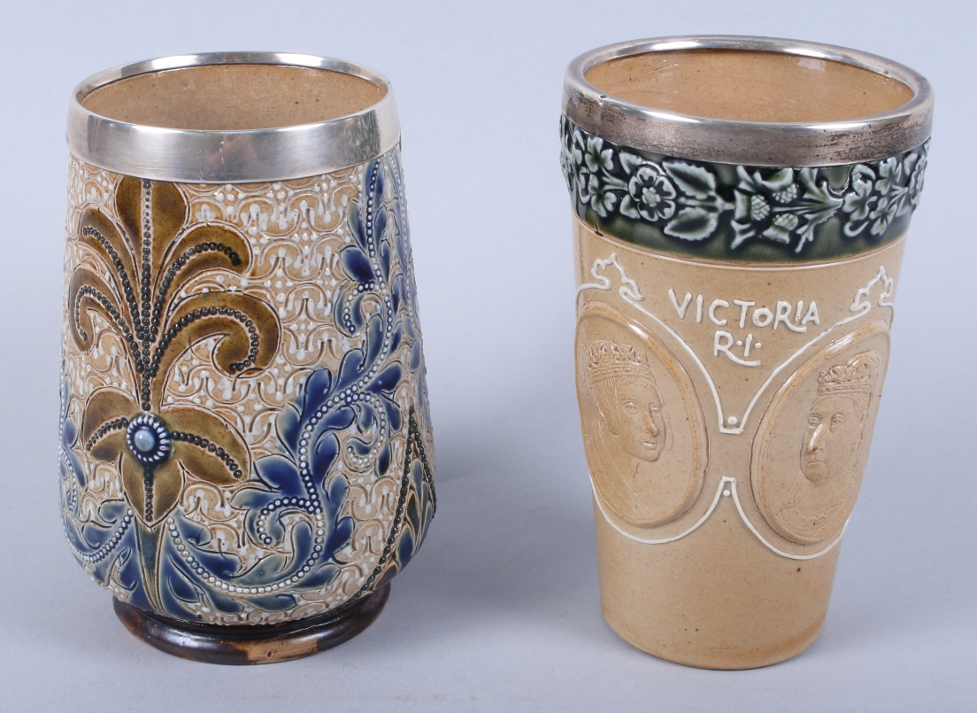 A Doulton Lambeth stoneware beaker, decorated two cameos of Queen Victoria with applied silver