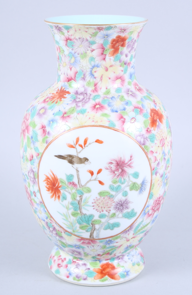 A Chinese porcelain baluster vase, decorated two panels of birds on a millefiori ground, seal mark