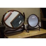 Two mahogany swing frame toilet mirrors on skeleton frames, and two wooden magazine racks