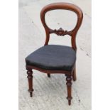 A late 19th century carved walnut loop back dining chair with stuffed over seat, upholstered in a