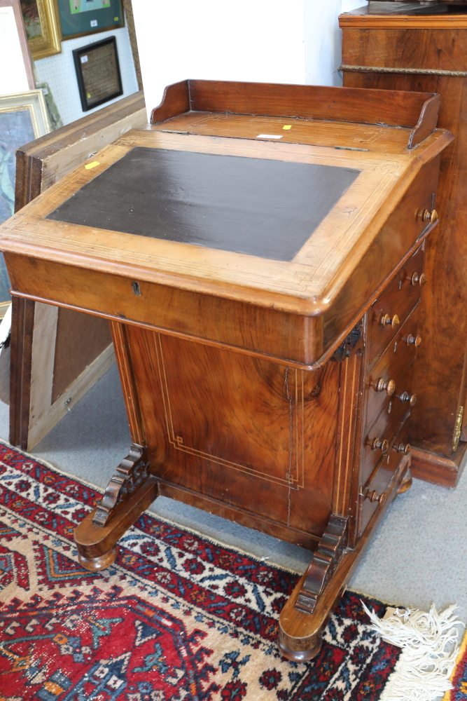 A late Victorian figured walnut Davenport with four side drawers and four faux drawers, on ceramic