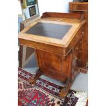 A late Victorian figured walnut Davenport with four side drawers and four faux drawers, on ceramic