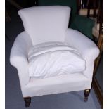 A mahogany framed low armchair, upholstered in a white ticking fabric, on castored supports