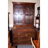 A George III mahogany bureau bookcase, the upper section enclosed two glazed doors, over base fitted